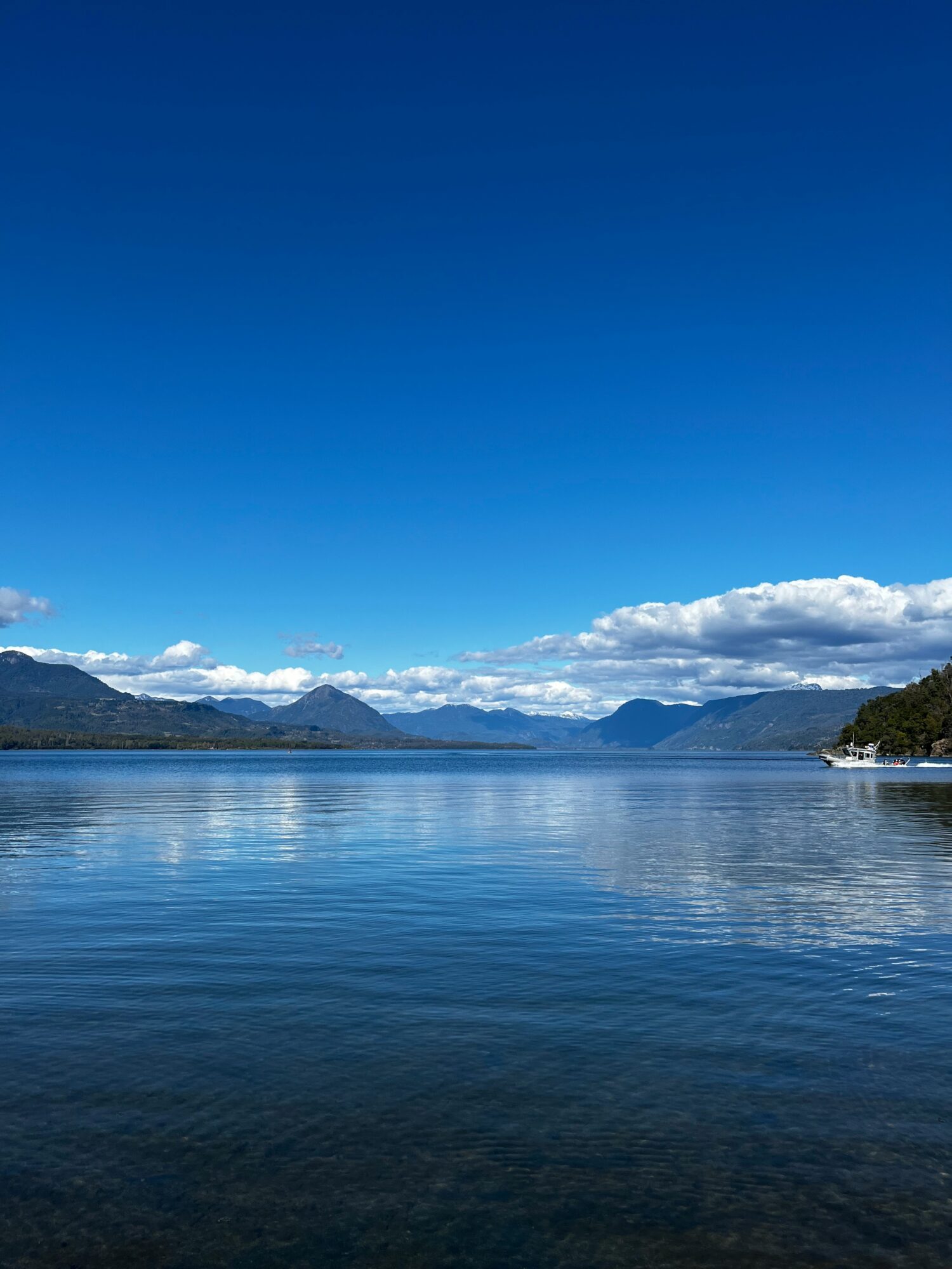 Calm blue water framed by volcanic landscapes in southern Chile